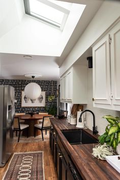 a kitchen with a sink, refrigerator and dishwasher next to a counter top