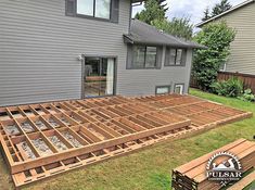 a wooden deck being built in front of a house