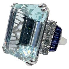 18K white gold ring with 30.93 carat aquamarine, 0.68 carat diamond and 0.69 carat sapphire. Sophia D by Joseph Dardashti LTD has been known worldwide for 35 years and are inspired by classic Art Deco design that merges with modern manufacturing techniques. Luxury Gia Certified Aquamarine Ring, Aquamarine Brilliant Cut Diamond Ring For Formal Occasions, Formal Aquamarine Diamond Ring With Brilliant Cut, Luxury Aquamarine Diamond Ring With Prong Setting, Luxury White Gold Sapphire Ring Collectible, Luxury Blue Topaz Ring In Platinum, Blue Gia Certified Emerald Ring For Formal Occasions, Formal Aquamarine Diamond Ring With Prong Setting, Formal White Sapphire Ring