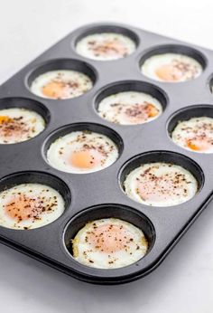 eggs in a muffin pan with seasoning sprinkled on top