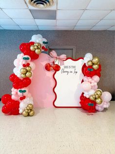 balloon arch with strawberrys and balloons on the front, saying she is the cherry on top