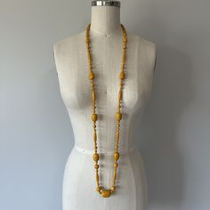 "A gorgeous mustard Bakelite necklace in great condition! Can be worn long or doubled up to create a shorter look over the chest area. This necklace is well made and is knotted with a cotton blend thread after each bead. Length (from back of neck to bottom front) - 25.8\" Tag - none Era - 60s  Material - cotton blend thread, bakelite beads" Vintage Yellow Jewelry With Large Beads, Vintage Polished Yellow Beads Jewelry, Vintage Yellow Jewelry With Polished Beads, Yellow Wooden Beads For Jewelry Making, Vintage Yellow Polished Beads, Vintage Yellow Round Bead Necklaces, Vintage Yellow Beaded Necklaces, Vintage Yellow Beaded Necklace, Vintage Yellow Single Strand Jewelry