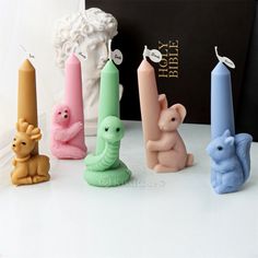 there are many small candles in the shape of animals and elephants next to each other