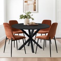 a black table with four orange chairs around it