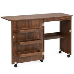 a wooden desk with wheels and shelves on the bottom, in front of a white background