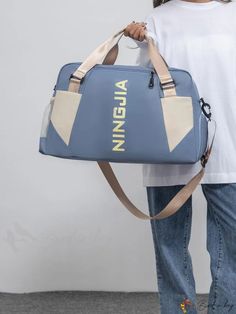 a person holding a blue and white bag with the word virginia printed on it's side