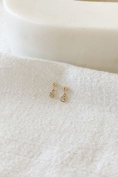 14k gold filled 3mm mini ball studs with 3mm cubic zirconia charms Please note that due to the handmade nature of this piece, they will vary slightly in appearance. There may also be slight color variations from soldering where the post meets the earrings, which is totally normal! Sold as a pair and comes with backings Gold filled is a soft metal so when putting the backings on and taking them off, hold the base of the post to avoid any bending Dainty 14k Gold Filled Piercings For Everyday, Dainty 14k Gold-filled Piercings, Dainty 14k Gold Filled Birthstone Earrings, Dainty Gold Piercing With Single Diamond, Everyday Gold Cubic Zirconia Piercings, Dainty Gold Piercings With Birthstone, Gold Piercing With Single Diamond As Gift, Gold Piercings With Single Diamond As Gift, Dainty Dangle Piercings