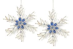 two snowflakes hanging from chains with blue beads