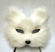 a white fox mask with black eyes