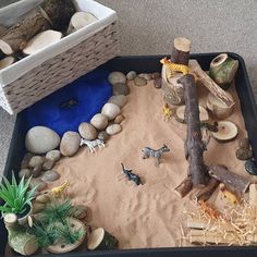 a sandbox filled with toys and rocks