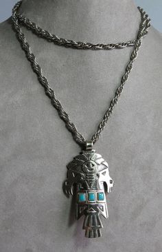 Here's a fun pendant necklace from Bell Trading Co.; 1960s or '70s,   It features a KACHINA figure and hangs from a 30" chain with no clasp.  The pendant measures 2.5/8" tall, has three turquoise bits set in and is in nice vintage condition.  Marked on the back with Bell Trading's logo.  Please see the picture with a coin for size comparison, as items may appear larger than they actually are. This is necessary to provide accurate details. Thanks for looking. And thank you for shopping sustainably. Retro Style Necklace With Large Pendant, Vintage Turquoise Pendant Necklace Collectible, Fun Pendant, Size Comparison, Silver Turquoise, 1960s, Coin, Jewelry Necklaces, Necklaces