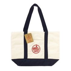 a white and blue tote bag with a tag on it