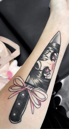 a woman's arm with a knife tattoo on the left side of her arm