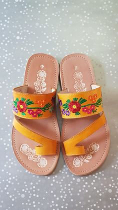 Mexican Sandals are made with soft insole and durable outsole. Rubber sole for comfortable walking! Strips are made with leather and decor with mexican embroidered. Huaraches are perfect as Summer shoes. They are unique and original. Easy to wear with jeans, dresses and shorts. *Need special size? - Please send a message, gladly assit you! We have more designs *In wholesale special prices! (Remember that because are made of leather it is required to use them to fit them) Shipping: Ready to ship Orange Single Toe Strap Sandals For Spring, Traditional Toe Post Sandals For Spring, Orange Sandals For Spring Festival, Yellow Huarache Sandals With Round Toe For Summer, Traditional Leather Sandals For Spring, Yellow Bohemian Sandals With Round Toe, Orange Round Toe Sandals For Festival, Bohemian Yellow Sandals For Spring, Vacation Sandals With Floral Embroidery And Open Toe