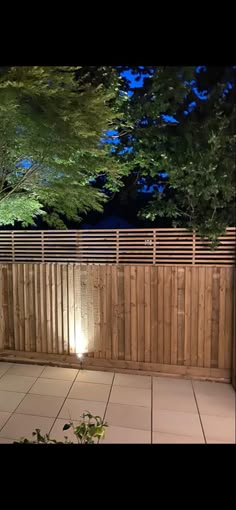 a wooden fence with lights on it at night