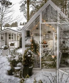 a small house is covered in snow and christmas lights