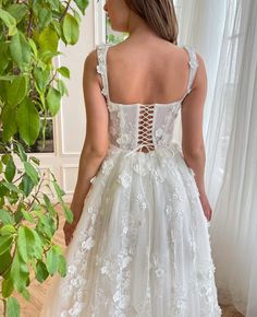 a woman in a white wedding dress looking back