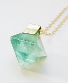 Featuring a beautiful pyramid shaped Blue Fluorite Stone which was hand framed into a 14k gold filled pendant. This necklace highlights the beautiful elements of this arresting stone. The stone measures approx. 15mm wide and hangs from 18" 14k gold filled chain.  Please note: Each stone can vary in blue color, cube shape and range between smooth to uneven surface. Green Fluorite Crystal Necklace, Green 14k Gold Spiritual Necklace, Spiritual Green 14k Gold Necklace, Green Spiritual Jewelry With Natural Inclusions, Spiritual Green Jewelry With Natural Inclusions, Gemstone Necklace Gift Diamond-shaped, Gemstone Diamond-shaped Necklace For Gift, Diamond-shaped Gemstone Necklace For Gifts, Unique Green Square Pendant Jewelry