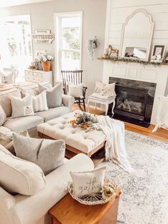 a living room filled with furniture and a fire place in the middle of the room