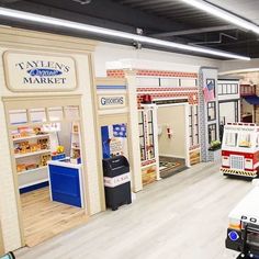 a police car is parked in the middle of a toy store's display area