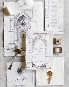 an assortment of wedding stationery items including envelopes, stamps and wax stampers