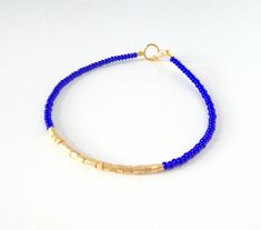 Adjustable Blue Friendship Bracelets With Gold Beads, Blue Beaded Minimalist Friendship Bracelets, Blue Friendship Bracelets With Gold Beads, Blue Dainty Beaded Friendship Bracelets, Dainty Blue Friendship Bracelet With Tiny Beads, Dainty Beaded Blue Friendship Bracelets, Dainty Blue Beaded Friendship Bracelets, Dainty Blue Friendship Bracelets With Tiny Beads, Minimalist Blue Bracelets With Tiny Beads