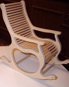 a wooden rocking chair sitting on top of a table