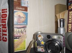 a camera sitting on top of a table next to books