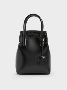 This Rene top handle bag features a vertical and structured silhouette that is able to fit longer items, such as a foldable umbrella or a small water bottle. With a black saffiano finish, this piece offers greater resistance to everyday scratches and wear-and-tear, so it is ideal for everyday use. Plus, they will complement any outfit of your choice. Carry it in hand via the structured top handles or simply clip on the detachable shoulder strap to use it as a crossbody bag. Foldable Umbrella, Small Water Bottle, Structured Top, Charles Keith, Handle Bag, Clip On, Top Handle, Umbrella, Carry On