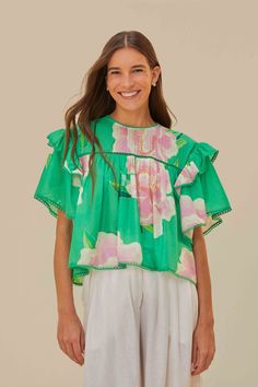 Embrace the vibrancy of the season with the Green Floral Vibing Blouse, a lively symphony of bright green hues and whimsical floral prints. This alluring piece features a round neckline complemented by fluttering ruffle sleeves and a delicate trim. The soft, flowing cut creates a playful yet refined silhouette that dances with each step. Perfect for infusing your wardrobe with a touch of tropical charm and effortless elegance. Composition 100% COTTONCare Instructions MACHINE WASH DELICATE CYCLE, DO NOT BLEACH, DO NOT TUMBLE DRY, LINE DRYING, IRON AT MEDIUM HEAT, DRY CLEAN WITH ANY SOLVENT EXCEPT TRICHLOROETHYLENESize and Fit Inches XXS XS S M L XL Bust 41 3/4 43 3/4 45 3/4 47 3/4 50 3/4 54 Waist 39 3/4 40 3/4 41 3/4 42 3/4 44 1/4 45 3/4 Length 20 20 3/4 21 1/4 21 3/4 22 2/4 23 Hip N/A N/A Spring Floral Print Green Blouse, Spring Green Tops With Floral Print, Spring Green Floral Print Blouse, Green Floral Print Blouse For Spring, Green Printed Spring Tops, Summer Green Floral Print Blouse, Green Floral Print Summer Blouse, Spring Green Blouse, Green Floral Print Short Sleeve Top