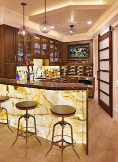 a kitchen with marble counter tops and stools