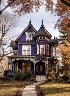 a purple victorian house in the fall