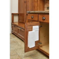 an open cabinet with papers on it in a kitchen