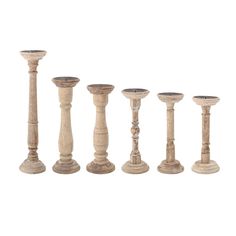 six wooden candlesticks are lined up in a row