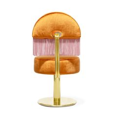 an orange and pink chair with a gold base