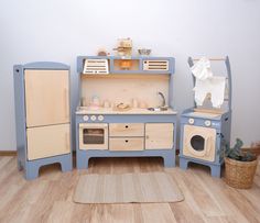 a child's play kitchen set in blue and beige