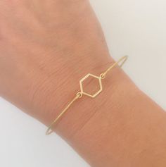 Geometric Jewelry - Hexagon Bracelet - Minimalist Jewelry - A gold tone hexagon charm will be transformed into a minimalist geometric bracelet with a brass band. I can also make this geometric minimalist bracelet with a 14k gold filled bangle band. If you would like this option for your geometric bangle bracelet, select from options when ordering.Please specify SIZE in notes to seller during checkout for your geometric hexagon bracelet... Choose from one of my regular sizes below by measuring on Adjustable Geometric Gold Jewelry, Gold Geometric Bracelet For Gift, Minimalist Adjustable Geometric Jewelry, Minimalist Gold Hexagon Jewelry, Texas Bracelet, Hexagon Bracelet, Hexagon Jewelry, Geometry Jewelry, Chevron Jewelry