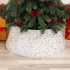 a potted christmas tree with red berries in it