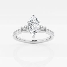 a white gold ring with an oval cut diamond and baguetts on the side