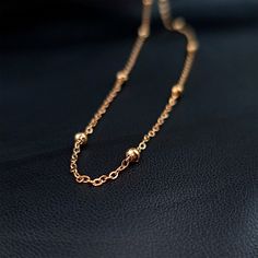 Product Details Hypoallergenic jewelry for sensitive skin Stainless Steel Ball Rose Gold Tone PVD Station Necklace Satellite Chain Layering Necklace Whether you're dressing up for a special occasion or seeking an everyday statement piece, this layering necklace is designed to enhance your style effortlessly. This stainless steel chain necklace is built to withstand the test of time. The durable construction ensures that you can enjoy its beauty and elegance for years to come. This women's neckla Luxury Rose Gold Necklace With Satellite Chain, Minimalist Rose Gold Metal Chain Necklace, Rose Gold Metal Chain Necklace, Elegant Rose Gold Jewelry With Satellite Chain, Delicate Rose Gold Metal Necklace, Rose Gold Metal Clavicle Chain Necklace, Rose Gold Chain Jewelry Gift, Rose Gold Metal Jewelry With Chain, Rose Gold Metal Choker Necklace