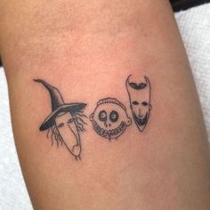 a tattoo with three masks on the arm and one is wearing a witch's hat