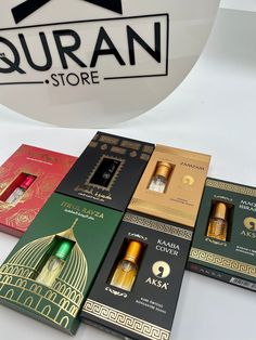 several different types of perfumes on display in front of a round sign that says guran store