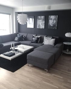 a black and white living room with grey couches