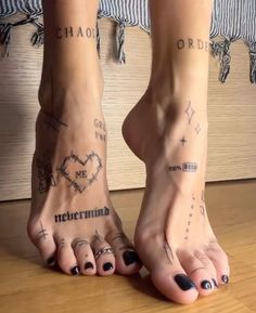 two people with tattoos on their feet standing next to each other and one has the word love