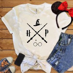 a white shirt with harry potter on it next to some shorts and headbands