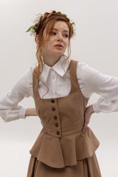 The vest is exquisite, suitable for different types of skirts and trousers. Thanks to the fitted silhouette, it will emphasize your waist. Made of cotton, the vest is pleasant to the touch. Details and Care: Ethically made of 100% сotton. Buttons made of coconut. Vest lining is 100% silk. Hand wash at 30oC. Drying in a horizontal unfolded form. Dry cleaning. Iron at a temperature of 150oC. Don't spin in a washing machine and dryer. Organic Clothing Women, Eco Brand, Fashion Vest, Cotton Sundress, Cotton Vest, Linen Short, Vest Outfits, Puffy Sleeves, Style Expert