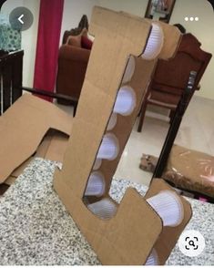 an open cardboard letter sitting on top of a counter next to a chair and table