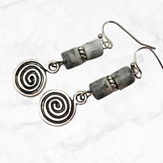 Antique silver ethnic earrings with speckled gray glass beads and spiral dangle charm. Bohemian style earrings with vintage beads from the early 1990's. Silver spiral charms are a good luck symbol.  Hypoallergenic ear wires (nickel and lead free). Choose ear wire style at checkout. A gift for you or someone special, earrings are carded and in an organza bag. More of my silver earrings: https://www.etsy.com/shop/JezaJewelry?ref=simple-shop-header-name&listing_id=1325834928&section_id=40032290 Lin Bohemian Gray Dangle Jewelry, Bohemian Gray Dangle Earrings, Special Earrings, Luck Symbol, Good Luck Symbols, Rustic Earrings, Reno Nv, Vintage Beads, Spiral Earrings