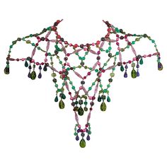 Dramatic bohemian capelet necklace from the 1960's USA. Handmade and composed of multicolored imported glass, resin beads and Swarovski crystal balls which form a capelet over shoulders. Wonderful colorations, perfect over a simple gown. 1960's USA. Neck Length 14 .25", plus necklace extender 2 7/8 " Center Front 11", Center Back 9" Bohemian Beaded Evening Necklaces, Multicolor Necklaces With Bead Caps For Party, Bohemian Bead Caps Necklace For Party, Simple Gown, Simple Gowns, Crystal Balls, Vintage Beads Necklace, Necklace Extender, Citrine Beads