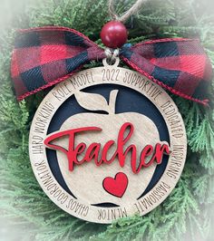 a christmas ornament with the word teacher on it